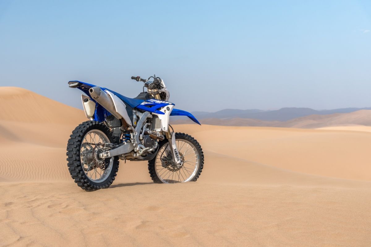 Una moto aparcada en plena ruta del Dakar. Fuente: iStock / ArefBarahuie