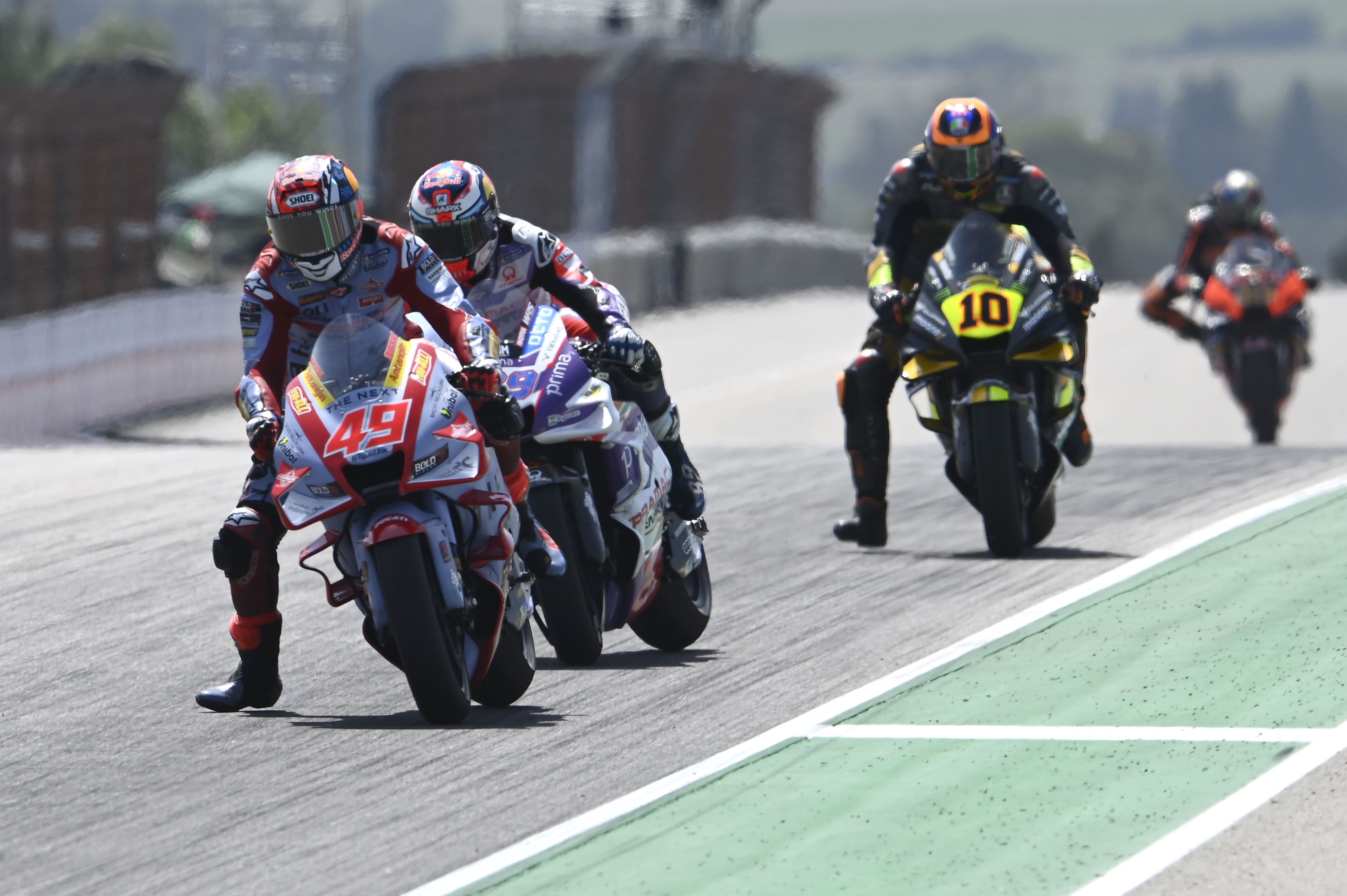 Fabio Di Giannantonio acechado por Jorge Martín ante Luca Marini y Brad Binder, MotoGP Sachsenring 2022