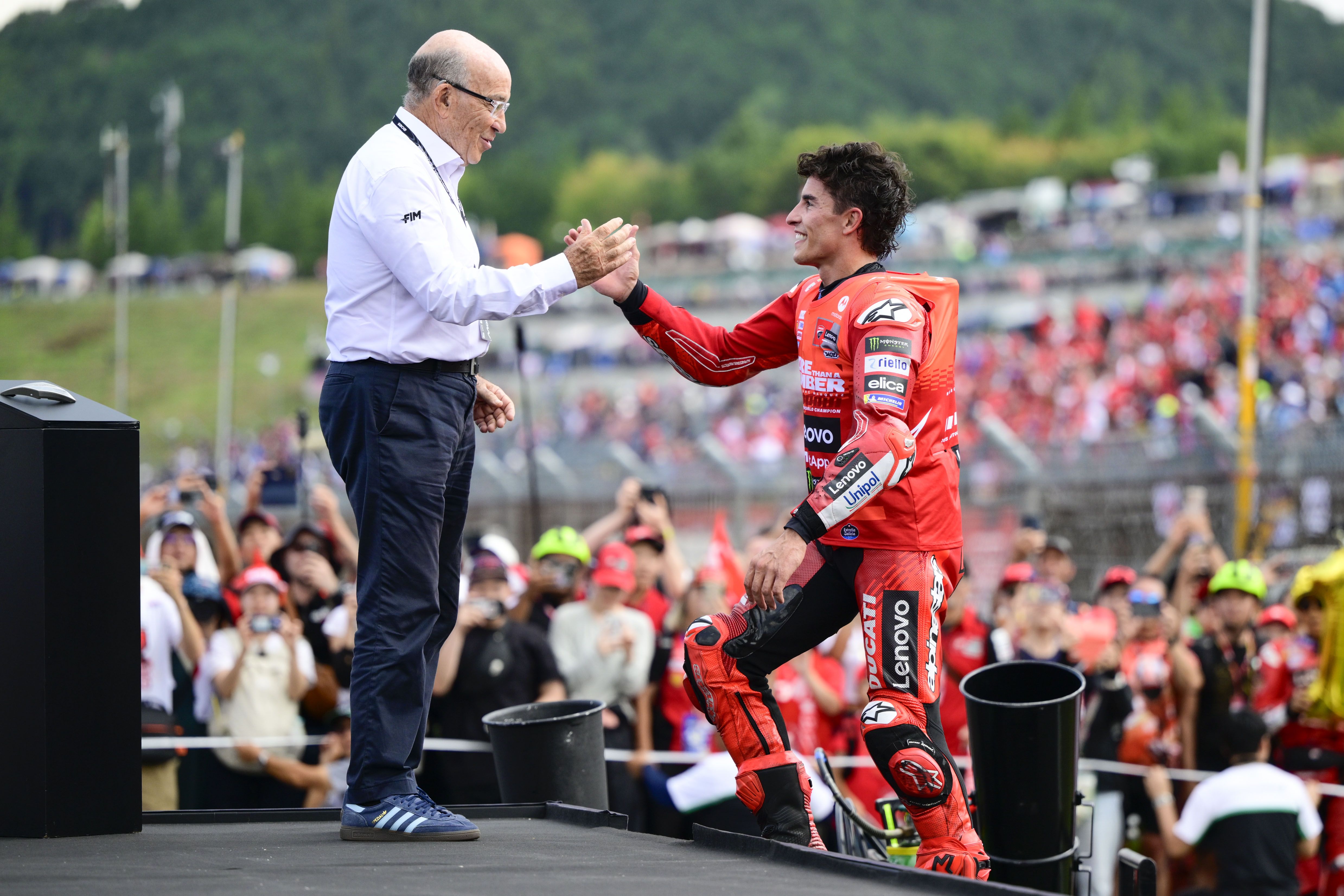 Carmelo Ezpeleta recibiendo a Marc Márquez en su último título de MotoGP