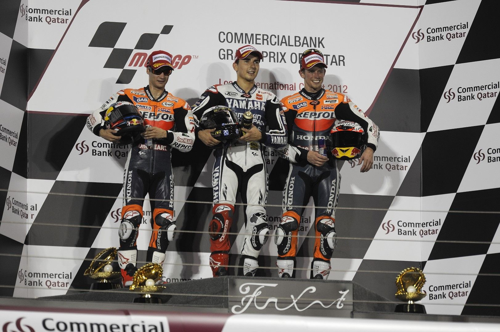 Pedrosa, Lorenzo y Stoner en el podio de Losail, en 2012.