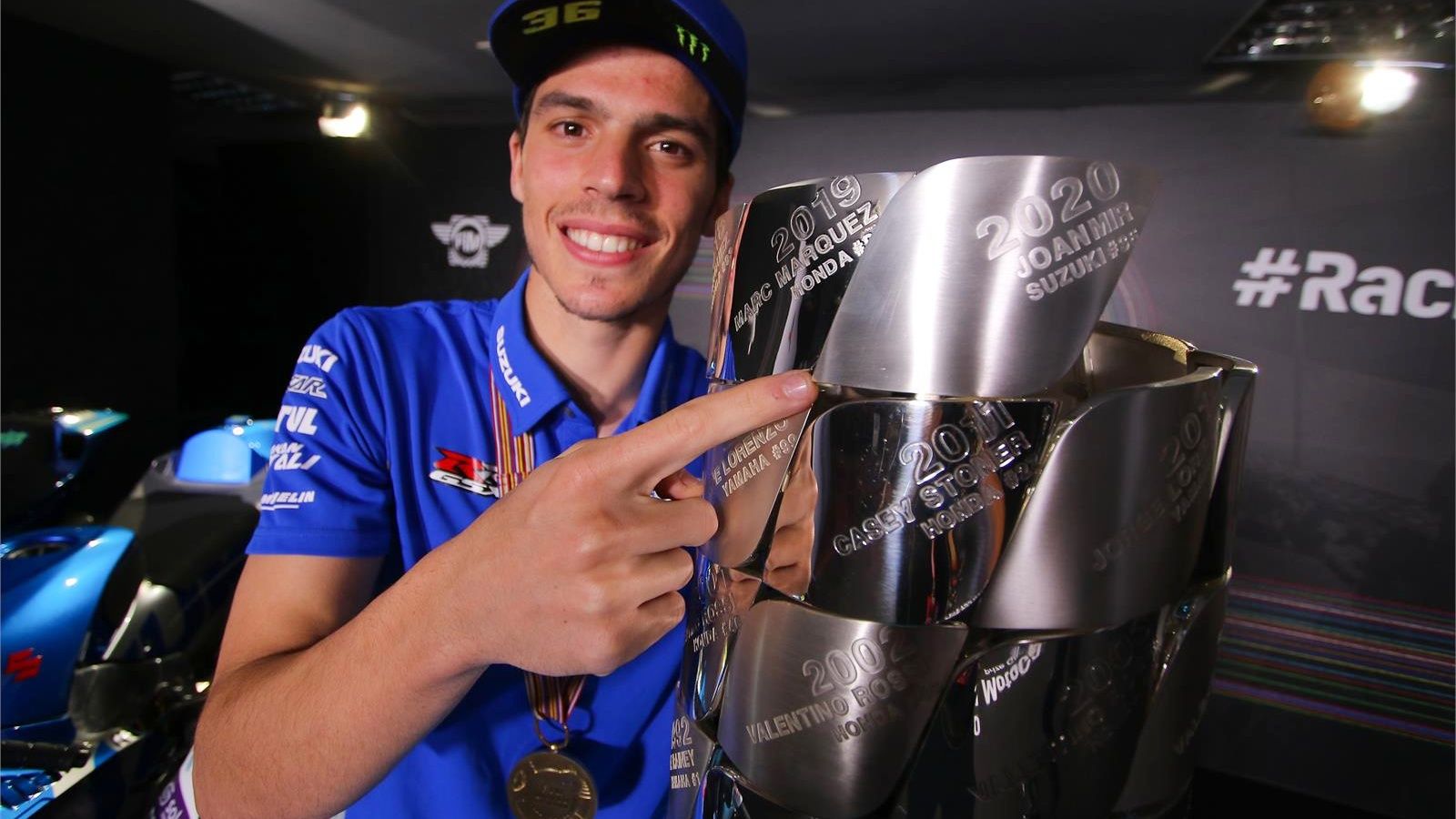 Joan Mir señala su nombre en el trofeo de MotoGP como campeón de 2020